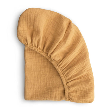 Soft, breathable muslin cotton baby fitted sheet by OKEYWOW on a crib mattress, solid color, designed for newborns.