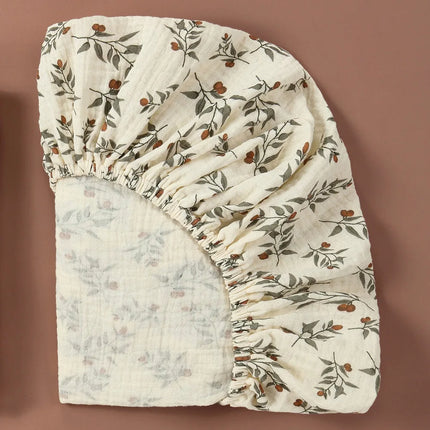 Breathable muslin cotton baby fitted sheet by OKEYWOW on a crib mattress, solid color, soft and snug for newborns.