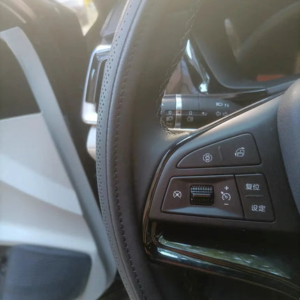 NAPA leather 15-inch universal perforated non-slip breathable steering wheel cover in black, fitted on a car wheel.