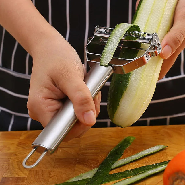 OkeyWOW stainless steel vegetable peeler with multifunctional blade for peeling potatoes, carrots, and shredding fruits in the kitchen.