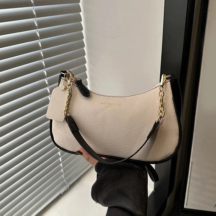 Luxury OKEYWOW cherry pendant shoulder bag for women, soft lychee leather casual dumpling-style handbag with underarm design.