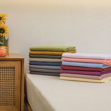OKEYWOW solid color single or double bed sheet, machine washable dorm bedding linen shown on a neatly made bed with pillows not included
