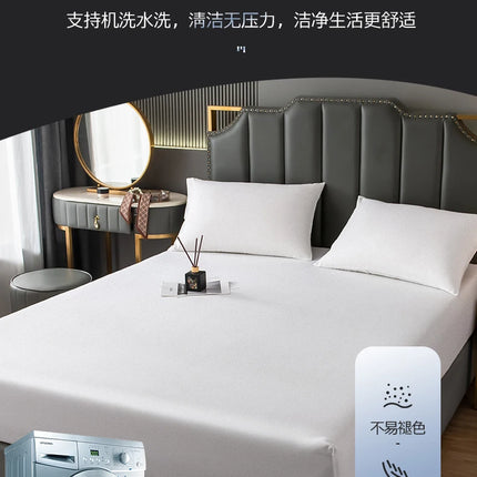 Okeywow solid color fitted sheet elastic mattress cover on a double bed, showing its snug fit and smooth fabric surface.